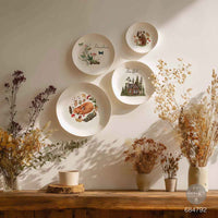 Decorative wall with plates featuring nature-themed designs. Redesign with Prima transfer middy The Forager's Retreat.