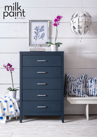 Night Swim Fusion Milk Paint. Blue dresser in a room with white walls, a bench, and decorative items.