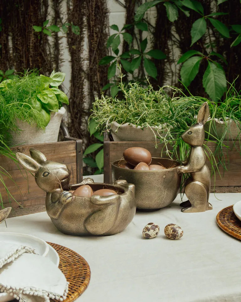 Decorative bunny-shaped bowls with eggs on a table outdoors. French Country Rabbit Sweets bowl lying down 