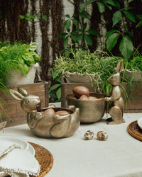 Decorative bunny-shaped bowls with eggs on a table outdoors. French Country Rabbit Sweets bowl lying down 