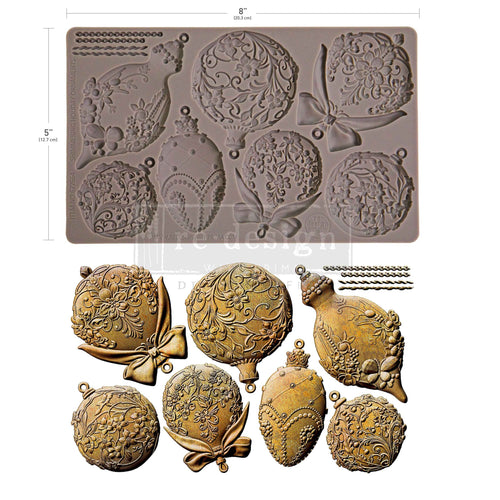 Decorative mold with intricate designs and gold-colored castings on a white background Shimmering Holiday Ornaments Mould by Redesign with Prima