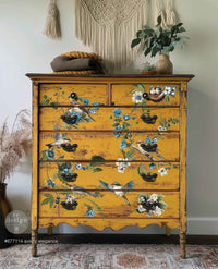 Redesign transfer Large Aviary Elegance Yellow dresser with floral and bird designs in a room with plants and decor.