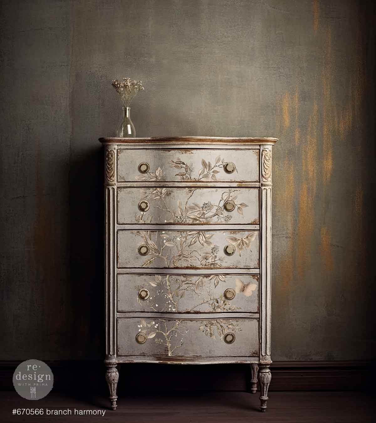 Redesign transfer Large Branch Harmony Decorative chest of drawers with floral patterns against a textured wall.