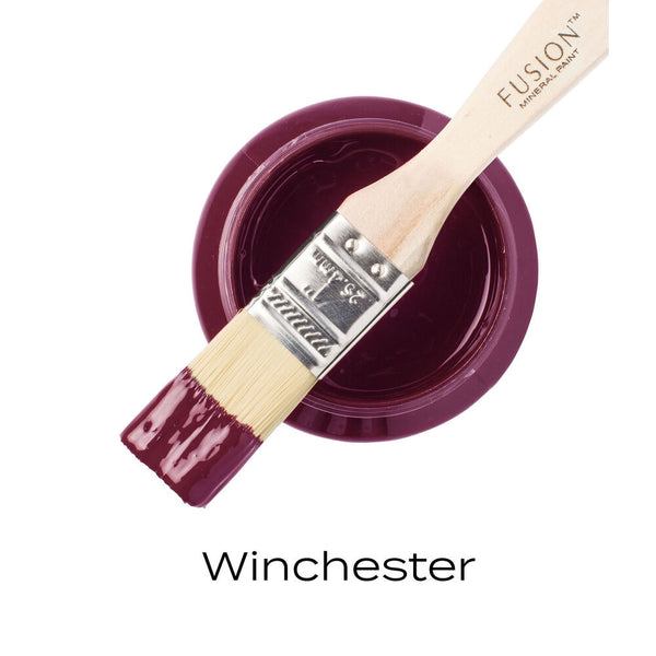 Fusion Mineral Paint brush with a sample of paint labeled 'Winchester' on a white background