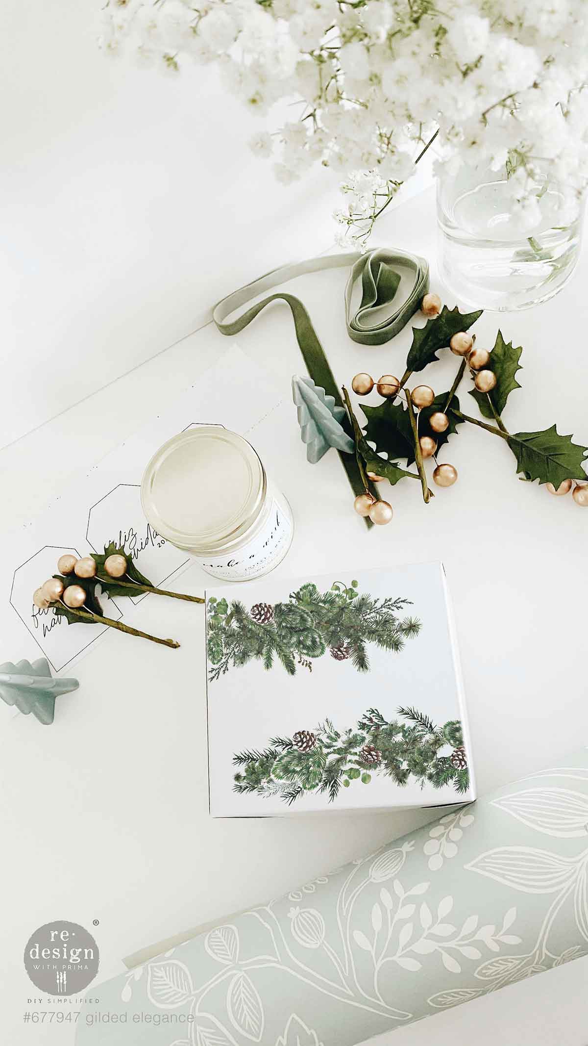 Redesign with Prima transfer middy Gilded Elegance 4 sheet Decorative table setting with floral arrangements and a card on a white surface.