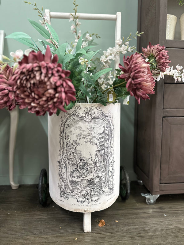 This is a very old trolley and we suggest it is used as a decor and display item only. It is not fit for travelling the pavement. Revamped using the softest of pinks Old Chiffon and our toile paint inlay. She looks perfect filled with flowers.