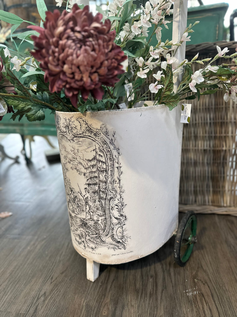 This is a very old trolley and we suggest it is used as a decor and display item only. It is not fit for travelling the pavement. Revamped using the softest of pinks Old Chiffon and our toile paint inlay. She looks perfect filled with flowers.