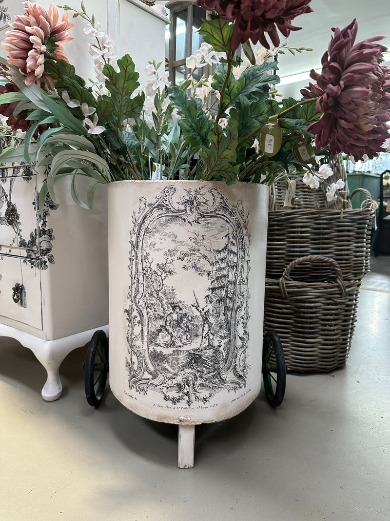 This is a very old trolley and we suggest it is used as a decor and display item only. It is not fit for travelling the pavement. Revamped using the softest of pinks Old Chiffon and our toile paint inlay. She looks perfect filled with flowers.