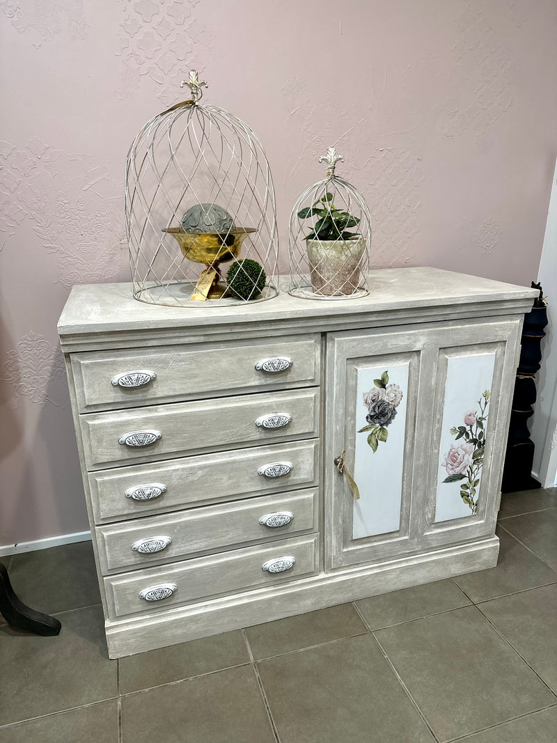 Using the Chateau method layering paint and wax has created this unique Olde Worlde look on this solid sideboard. Shades of grey, white and floral transfers complete the look, Dimensions approx 900mm height x 1200mm length.