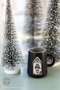 Redesign with Prima transfer middy Village of Wonder 4 sheet Black mug with house design on a light surface with decorative trees in the background